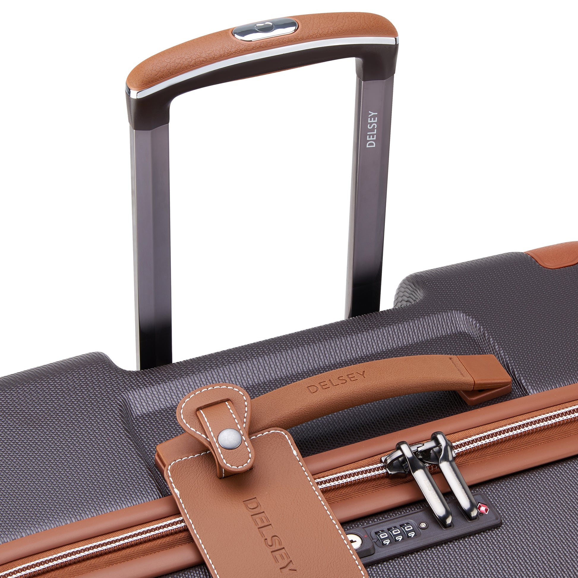 Alça superior em couro marrom e puxador retrátil da mala média DELSEY com zíper antifurto, combinação de design robusto e detalhes elegantes para viagem.