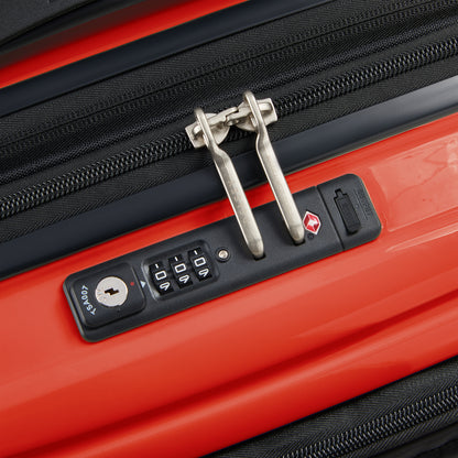 Fecho com zíper antifurto e trava TSA em mala rígida laranja expansível da DELSEY, ideal para viagens seguras com compartimento para notebook.