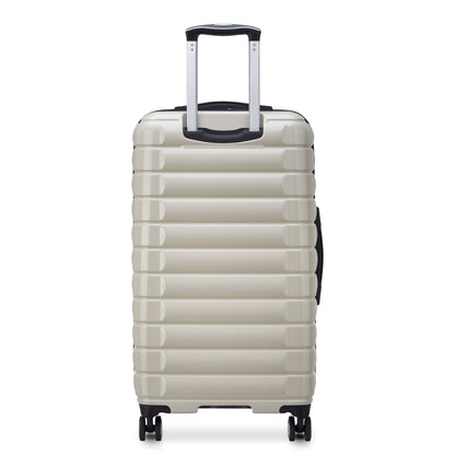 Mala rígida off white de formato trunk da DELSEY com design durável, rodas giratórias e puxador telescópico, ideal para viagem e despacho.